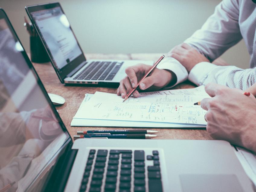 an image of a man at a desk creating a recruitment strategy