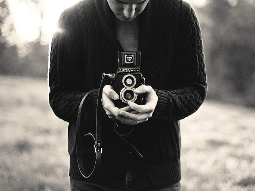 an image of a man holding a camera