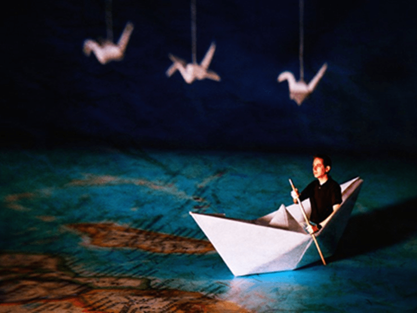 an image of a man in a paper boat on a map