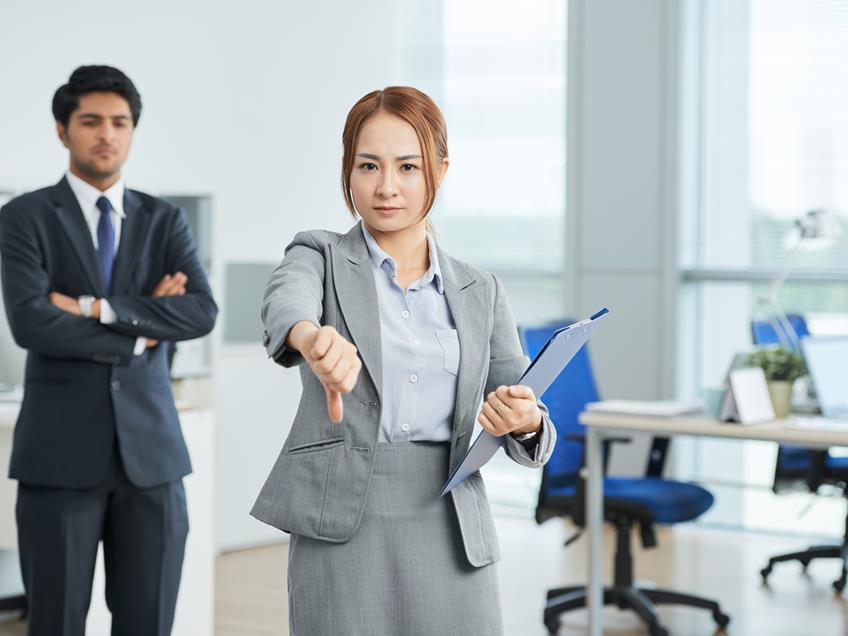 Woman putting her thumbs down as she finds out that Shortage Of White-Collar Staff Reaches Breaking Point